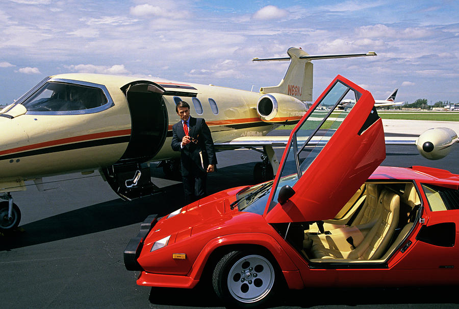 Successful businessman from the 90s between Lamborghini and Lear Jet