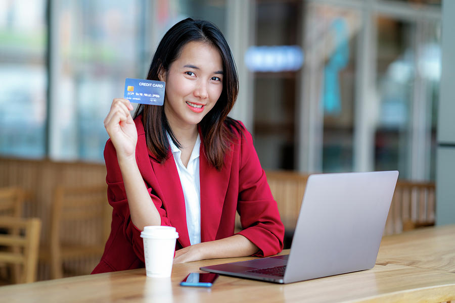 Asian girl shopping online with credit card